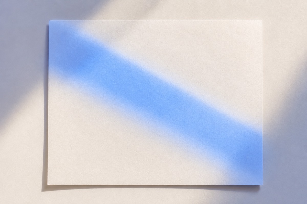 A sheet of résumé paper catching a diagonal band of blue light